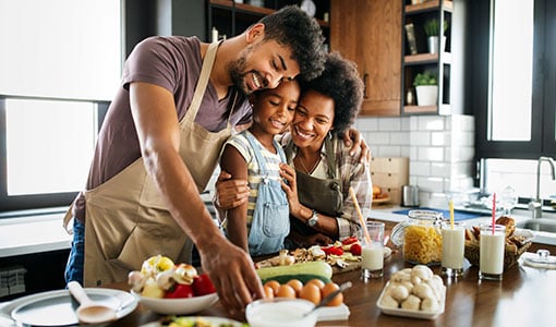 happy family preparing healthy food in kitchen together
