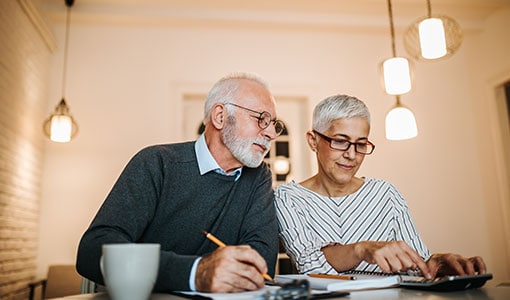 mature couple sitting in office discussing finances